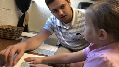 Butler College of Ed student Riley Strauss teaches a math strategy to a kindergarten student